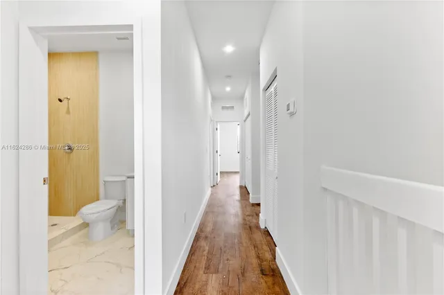 a view of a bathroom from a hallway