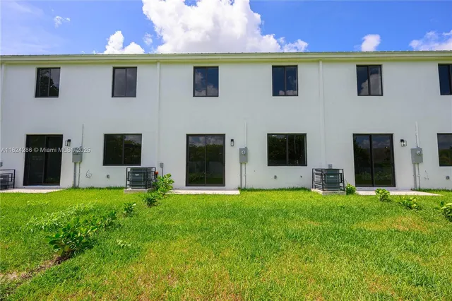 a view of a house with a yard and sitting area