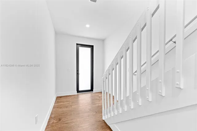 a view of staircase with white walls and a window