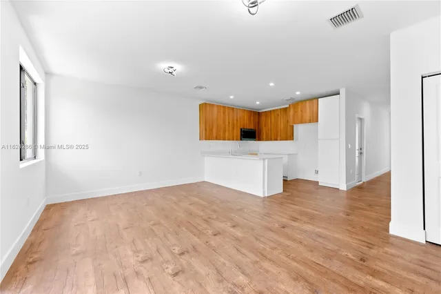 a view of a kitchen with a sink and a window
