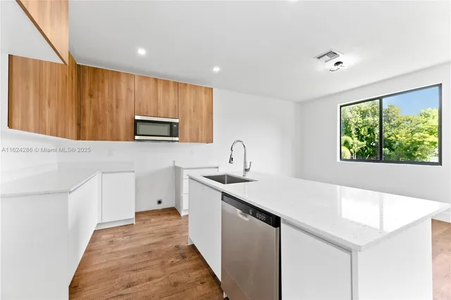 a kitchen with a sink stove and microwave