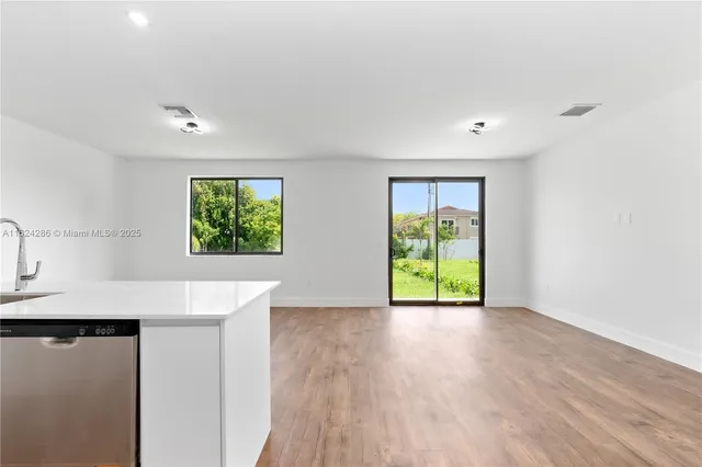 a view of a kitchen with a sink and a window