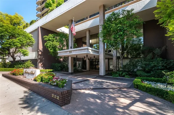 front view of a house with a yard and potted plants