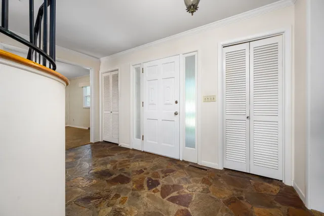 a view of a hallway with wooden walls and stairs