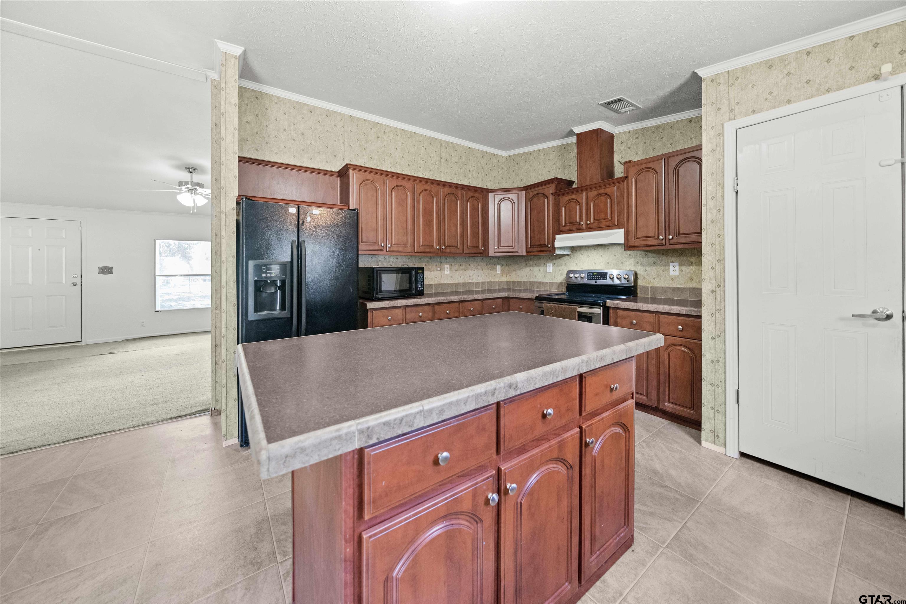 5611 Holiday Hills Road Tyler, TX 75708 - Photo 15 of 38 a kitchen with stainless steel appliances granite countertop a refrigerator a sink and a stove