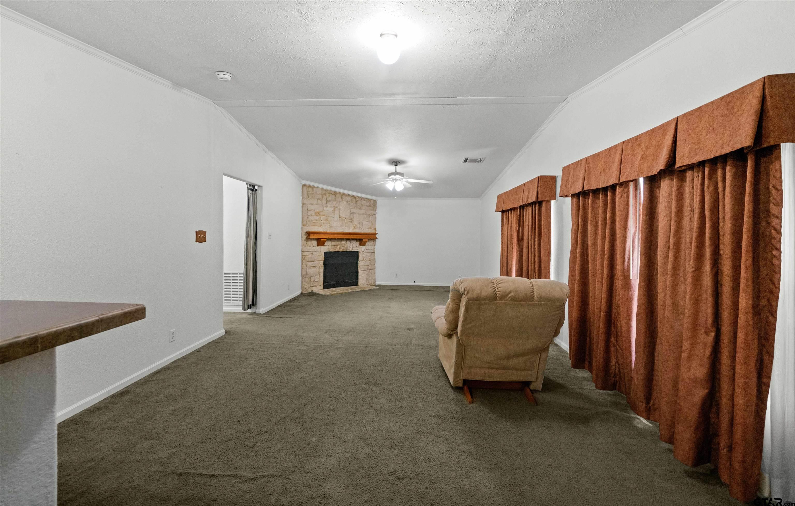 5611 Holiday Hills Road Tyler, TX 75708 - Photo 21 of 38 a living room with furniture and a rug