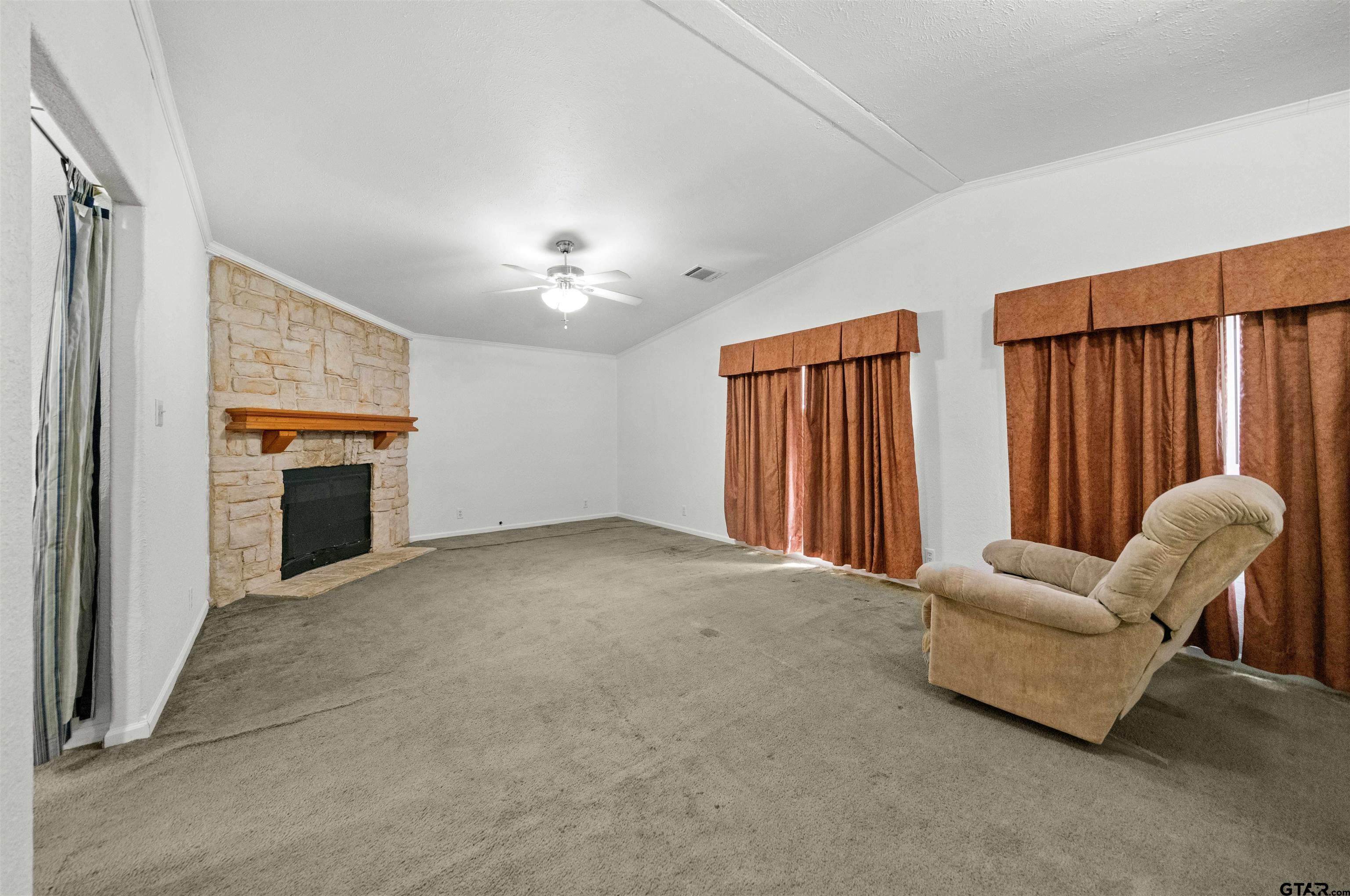 5611 Holiday Hills Road Tyler, TX 75708 - Photo 22 of 38 an empty room with furniture and windows