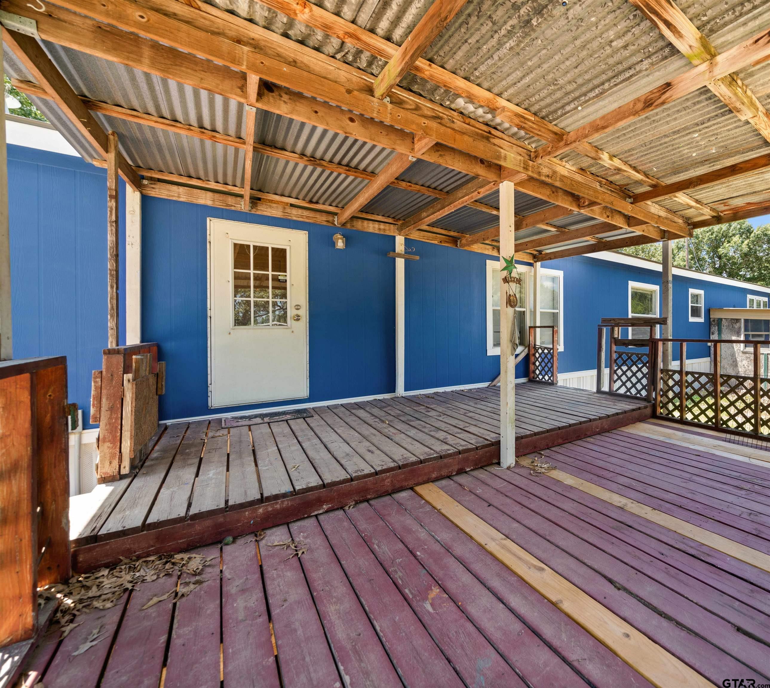 5611 Holiday Hills Road Tyler, TX 75708 - Photo 29 of 38 a view of a backyard with wooden floor