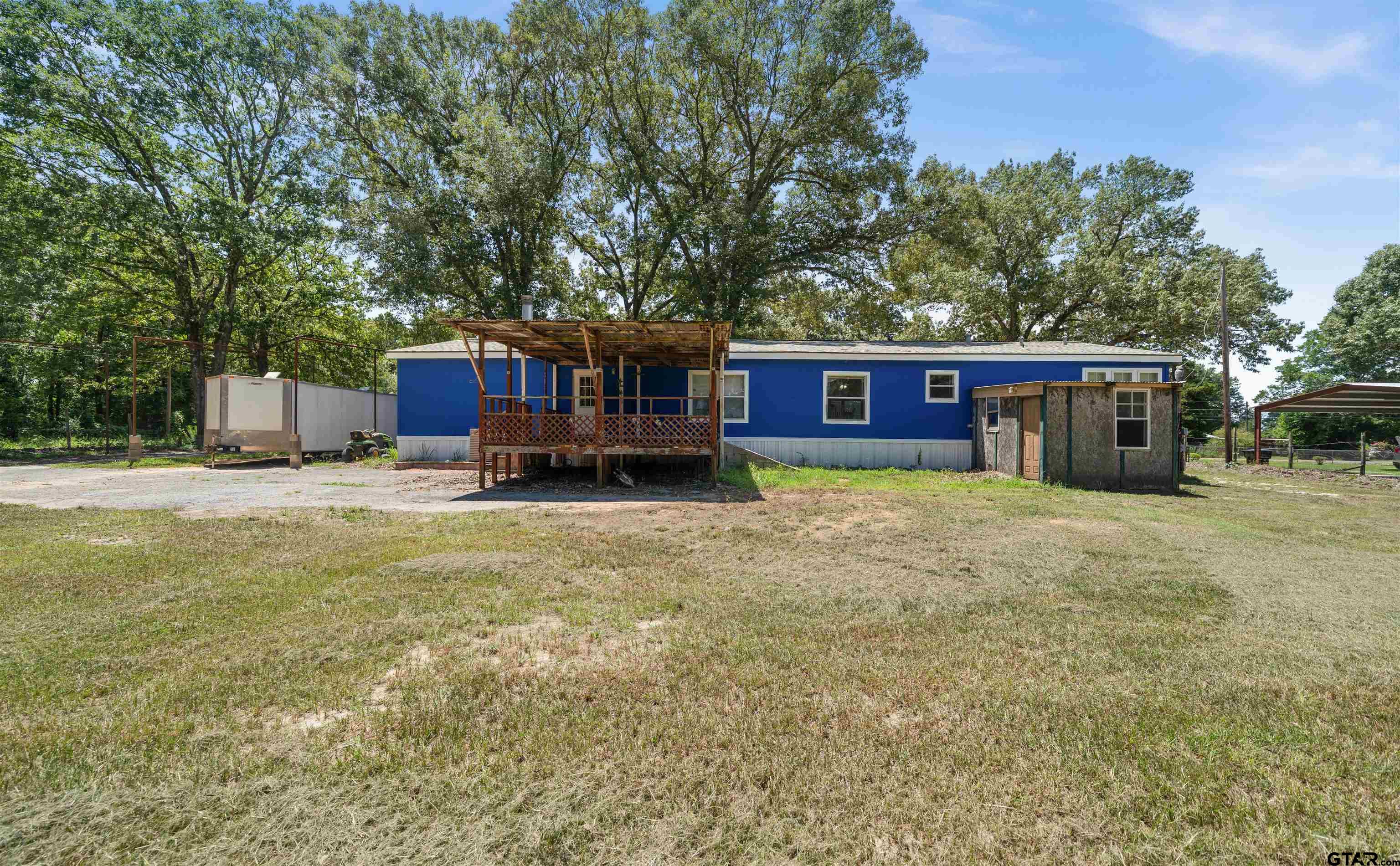 5611 Holiday Hills Road Tyler, TX 75708 - Photo 30 of 38 a view of a house with a yard and sitting area