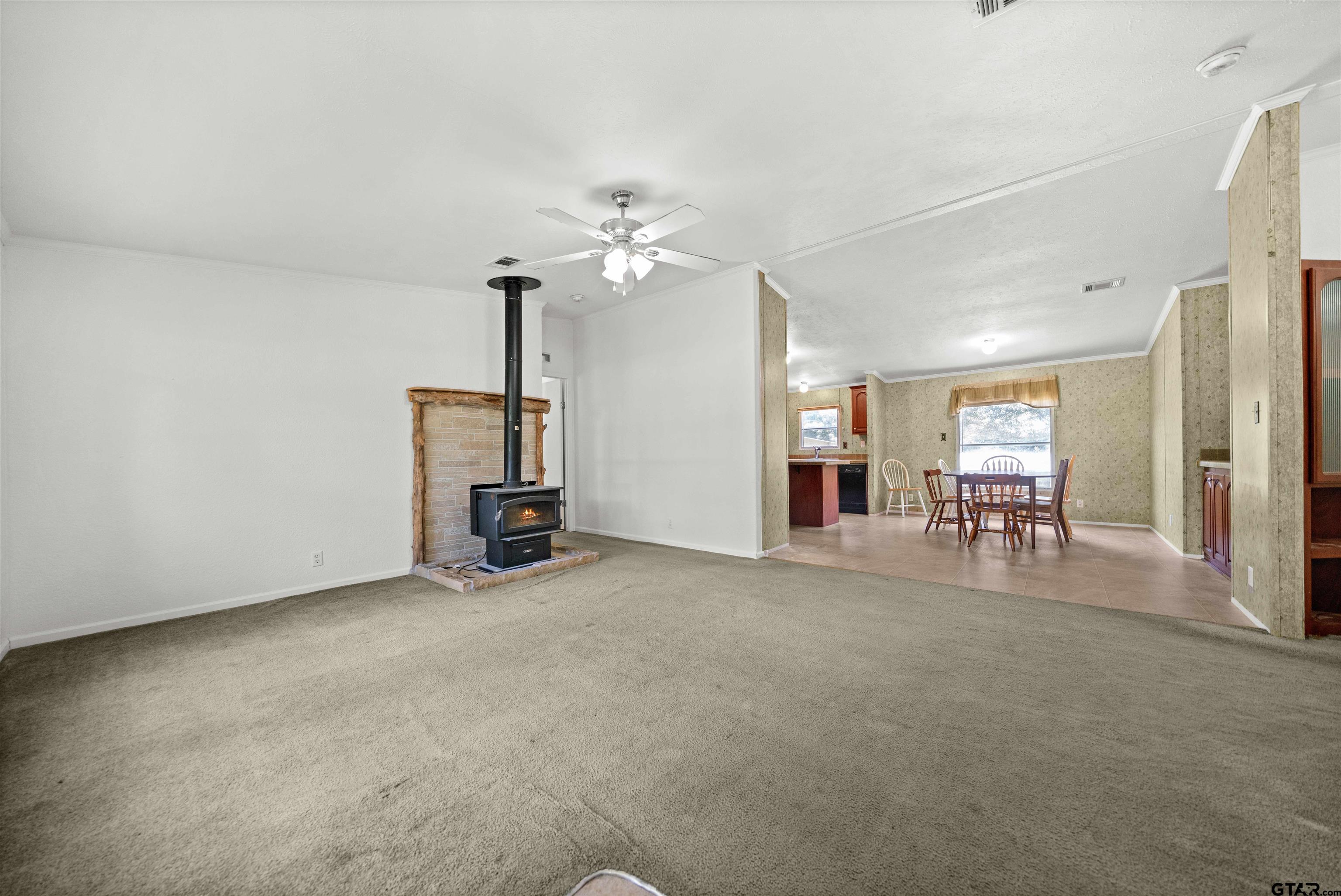 5611 Holiday Hills Road Tyler, TX 75708 - Photo 3 of 38 a view of a livingroom with a furniture and chandelier fan