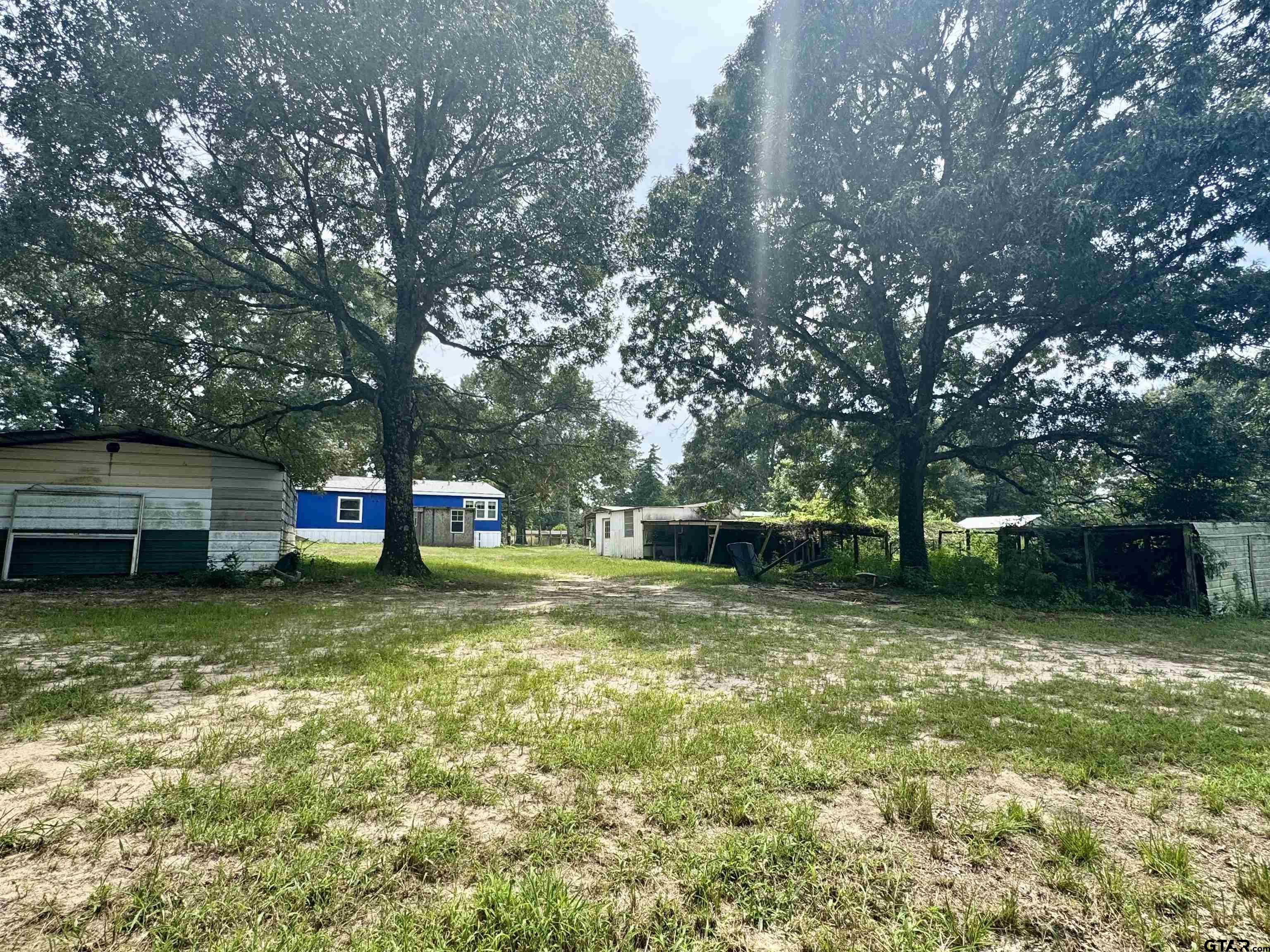 5611 Holiday Hills Road Tyler, TX 75708 - Photo 34 of 38 a view of a house with a yard