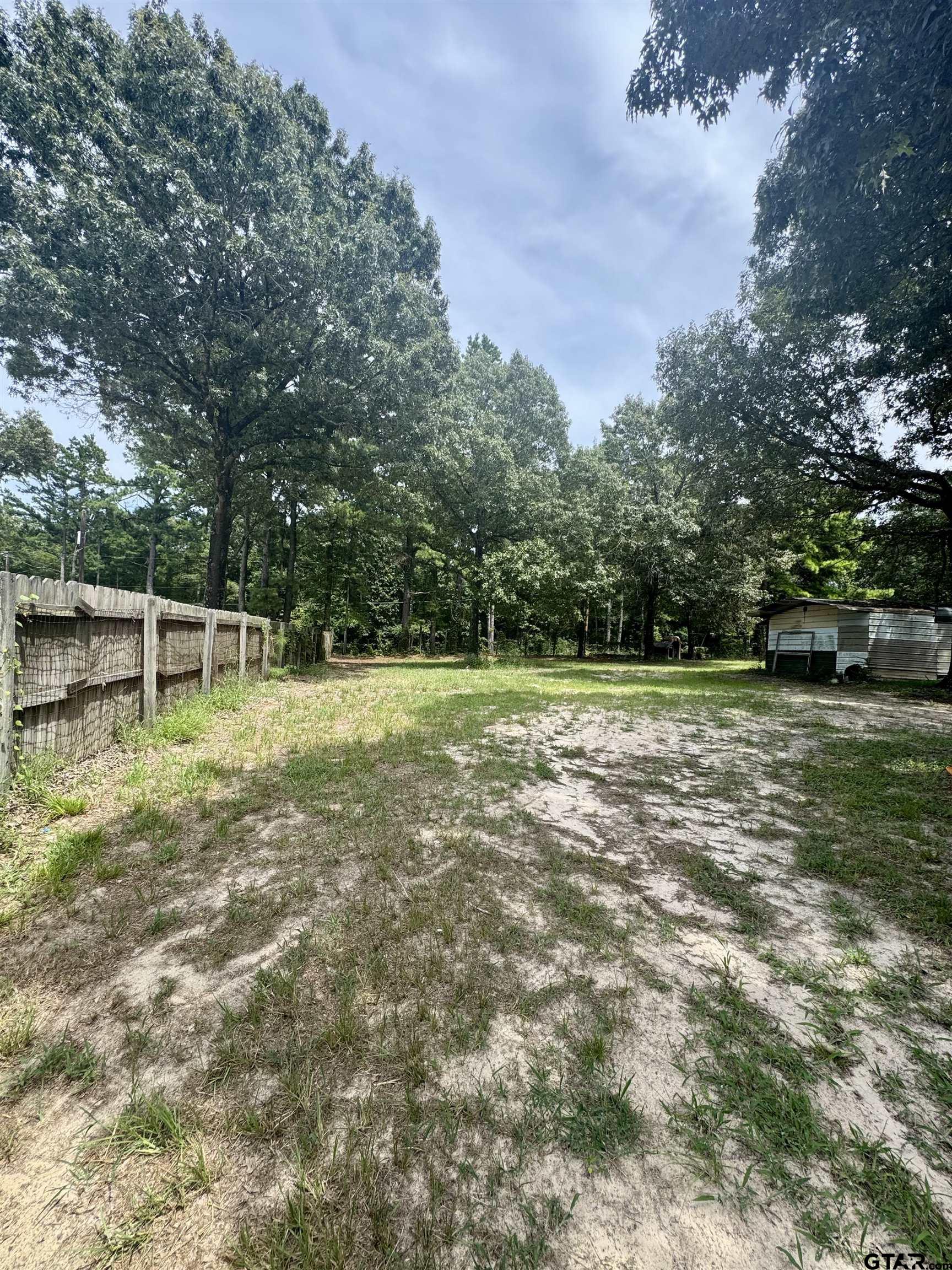5611 Holiday Hills Road Tyler, TX 75708 - Photo 35 of 38 a backyard of a house with lots of green space