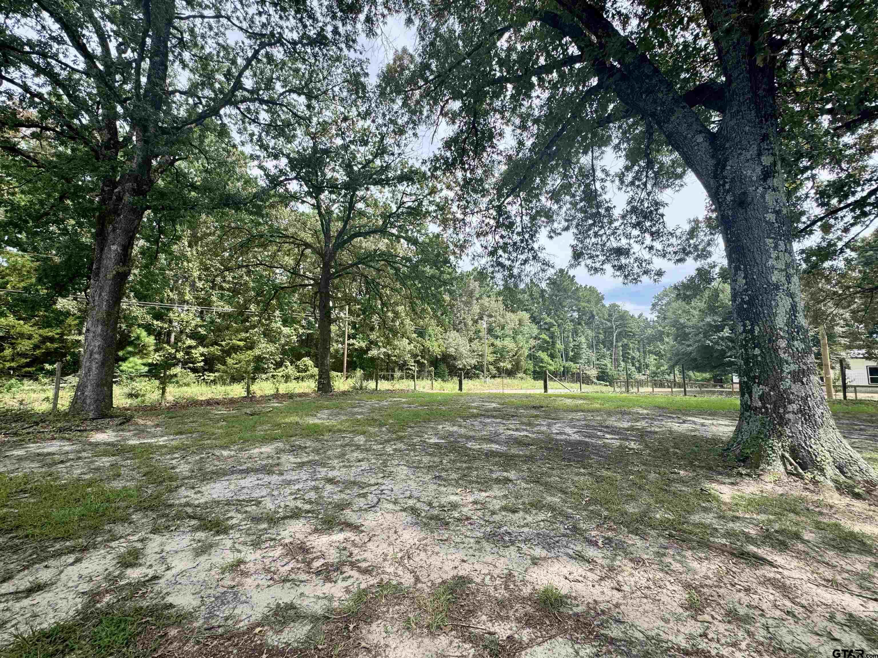 5611 Holiday Hills Road Tyler, TX 75708 - Photo 36 of 38 a view of a field with trees in front of it