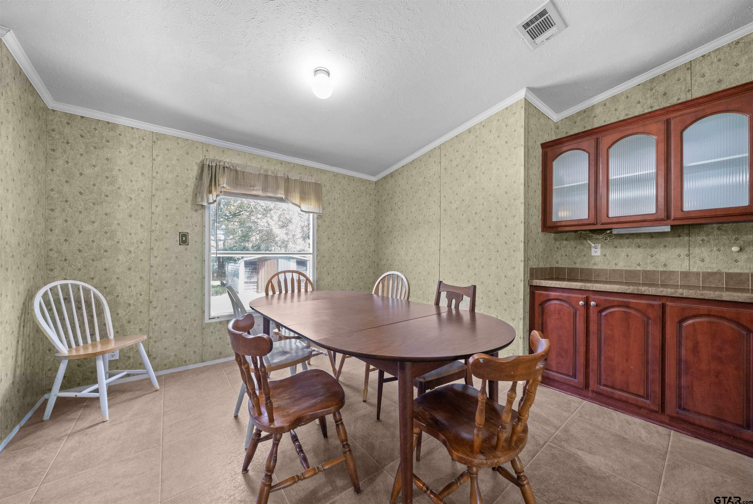5611 Holiday Hills Road Tyler, TX 75708 - Photo 4 of 38 a dining room with furniture and window