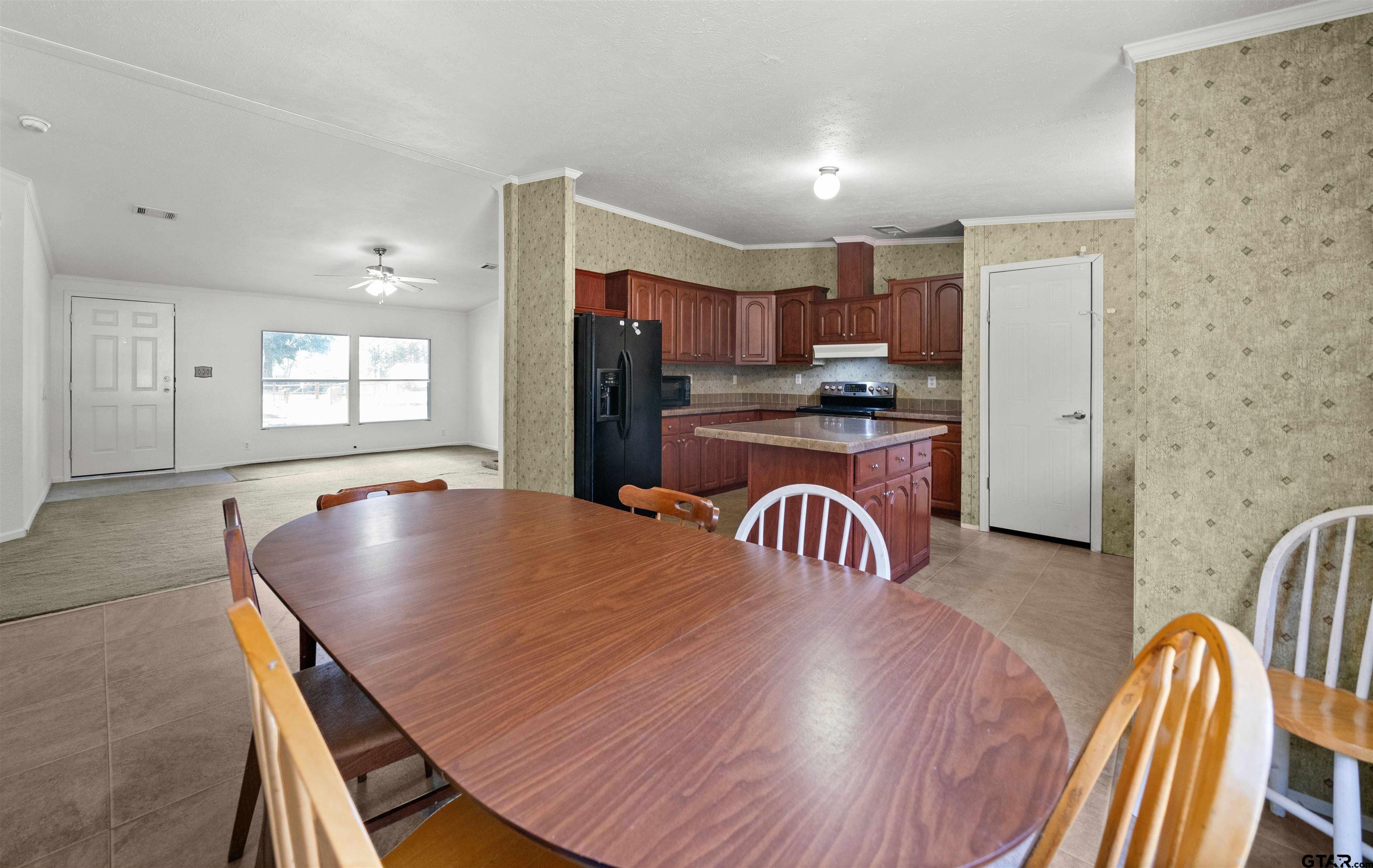 5611 Holiday Hills Road Tyler, TX 75708 - Photo 5 of 38 a living room with stainless steel appliances furniture a dining table and kitchen view