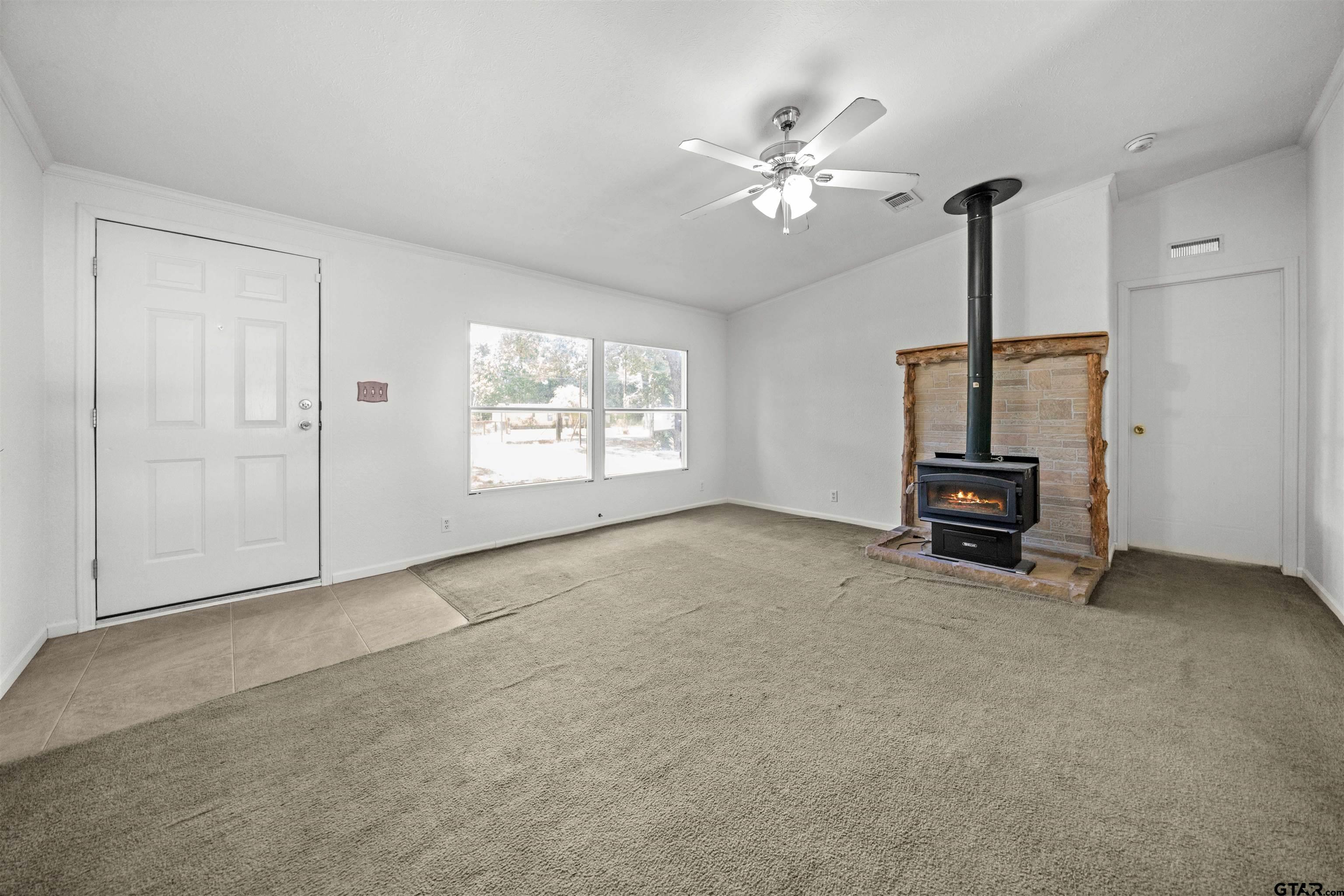 5611 Holiday Hills Road Tyler, TX 75708 - Photo 6 of 38 an empty room with windows and fan