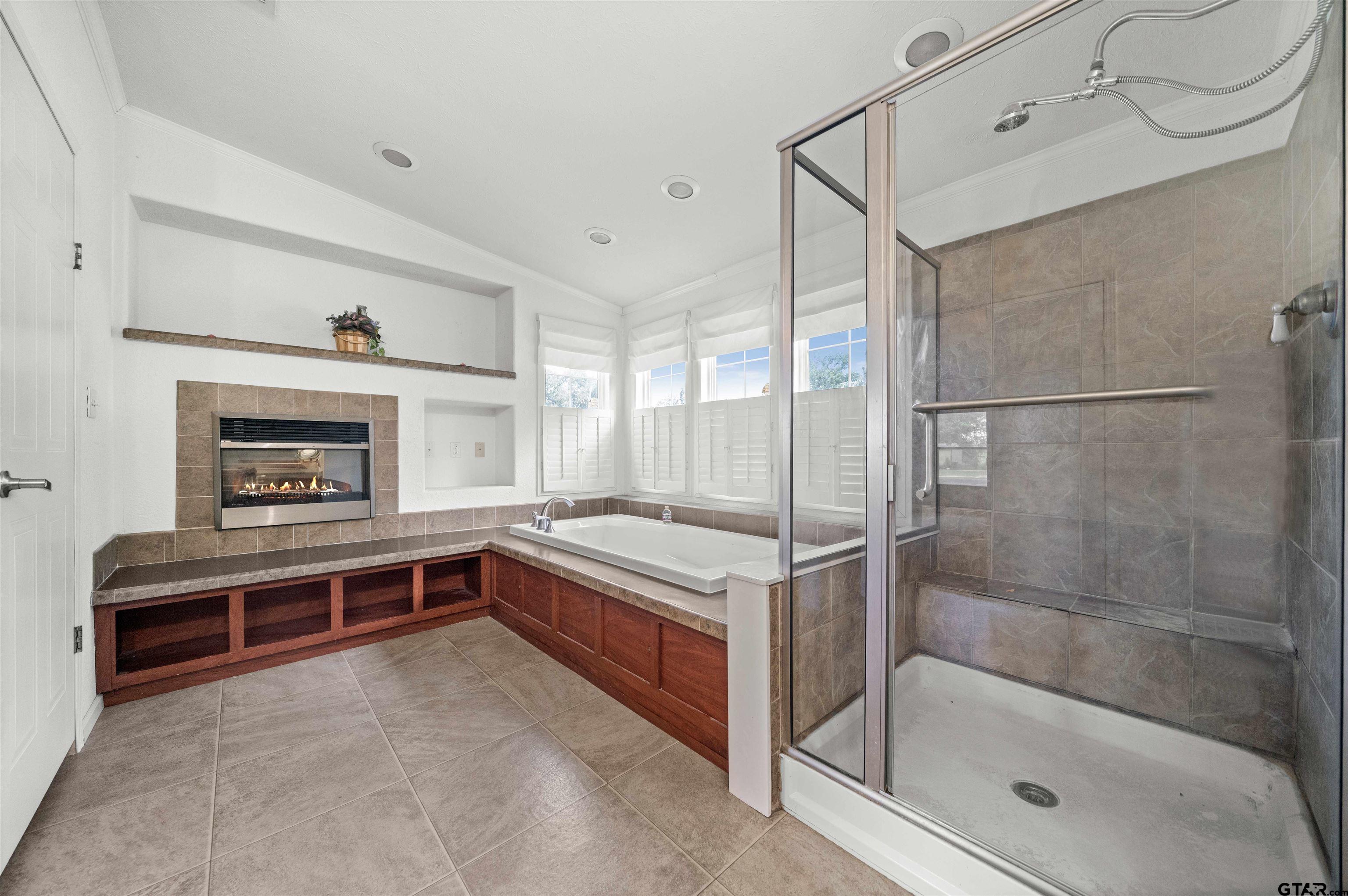 5611 Holiday Hills Road Tyler, TX 75708 - Photo 8 of 38 a bathroom with a bathtub and a shower