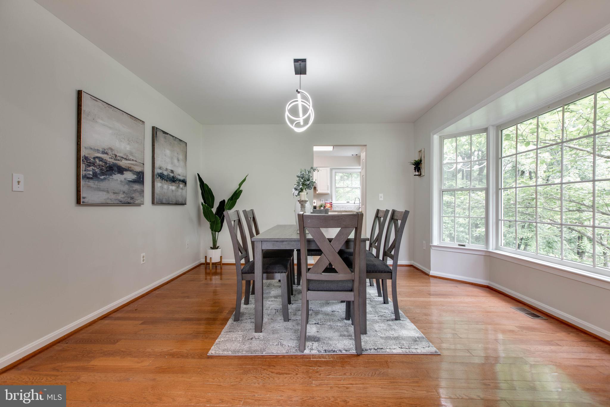 574 Pasture Brook Road Severn, MD 21144 - Photo 18 of 76 a view of a dining room with furniture window and wooden floor