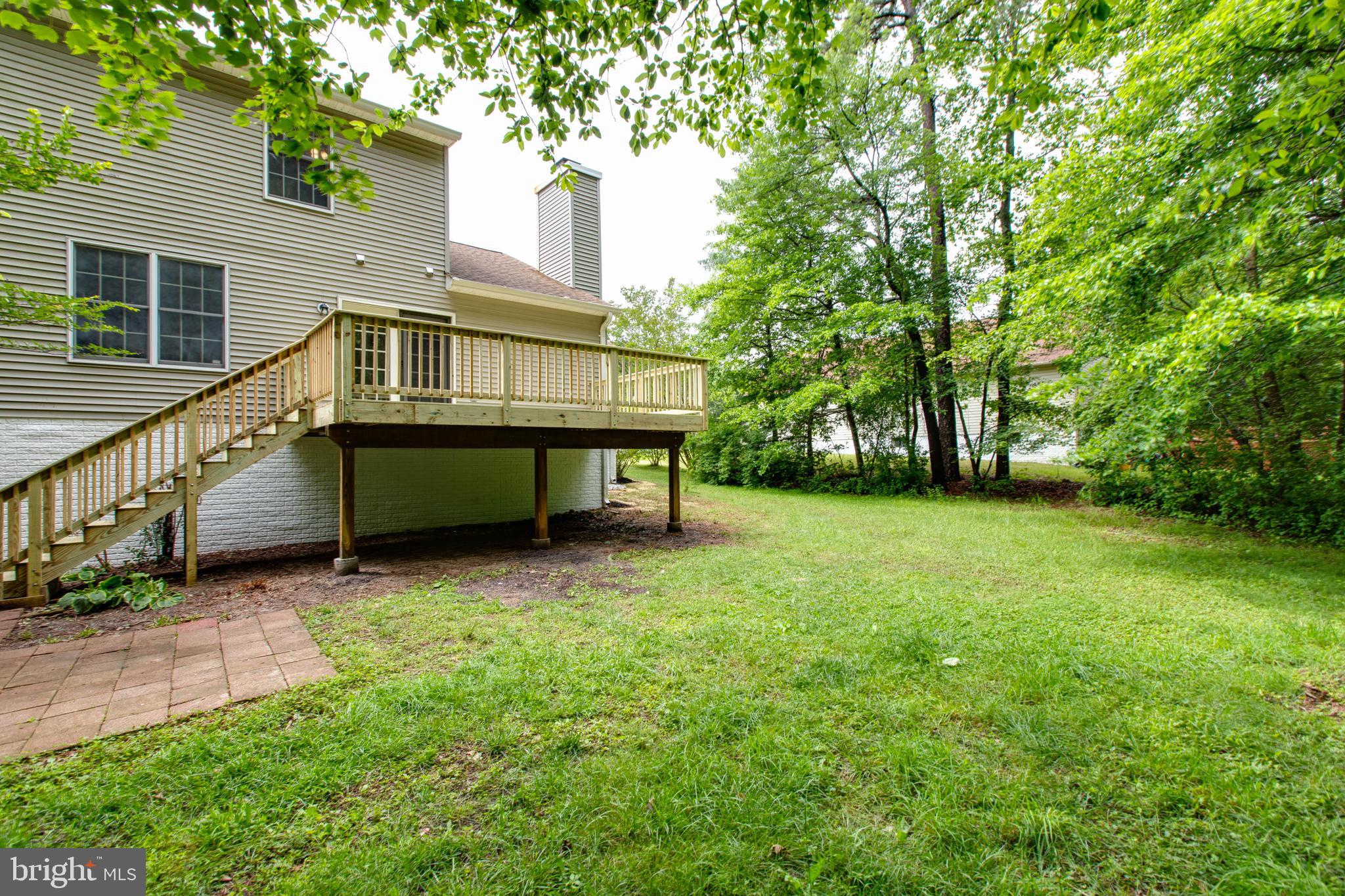 574 Pasture Brook Road Severn, MD 21144 - Photo 74 of 76 a backyard of a house with table and chairs