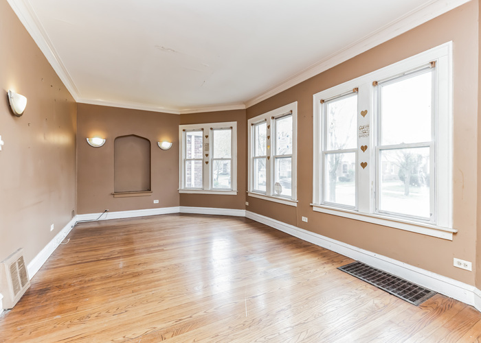10805 South Normal Avenue Chicago, IL 60628 - Photo 11 of 26 a view of an empty room with a window and wooden floor
