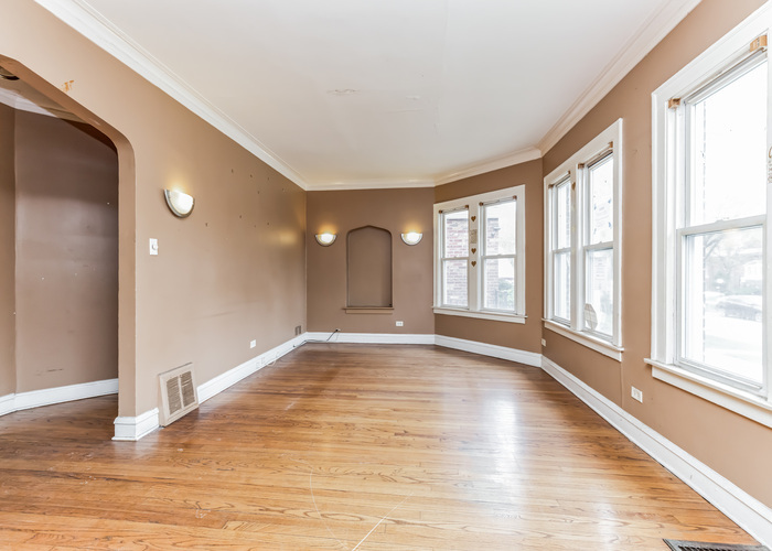 10805 South Normal Avenue Chicago, IL 60628 - Photo 12 of 26 a view of an empty room with wooden floor and a window