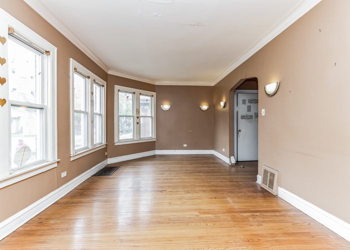 10805 South Normal Avenue Chicago, IL 60628 - Photo 13 of 26 a view of an empty room with a window and wooden floor