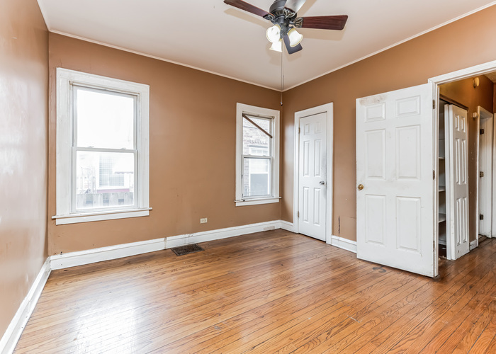 10805 South Normal Avenue Chicago, IL 60628 - Photo 16 of 26 a view of an empty room with wooden floor and a window