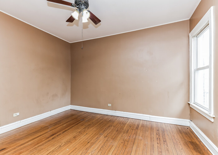 10805 South Normal Avenue Chicago, IL 60628 - Photo 19 of 26 wooden floor in an empty room with a window