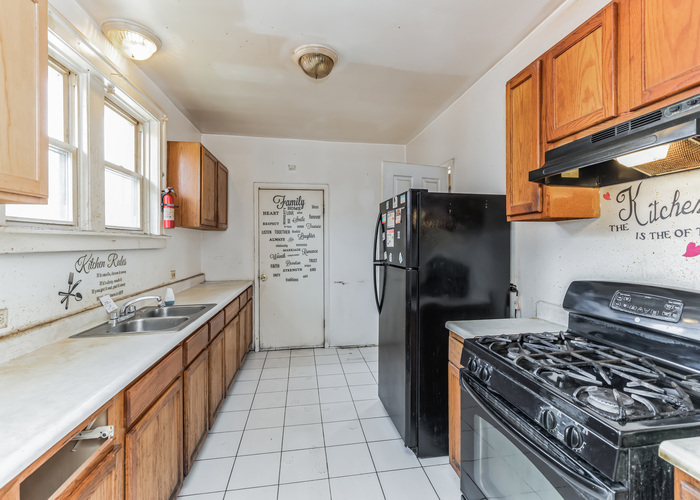 10805 South Normal Avenue Chicago, IL 60628 - Photo 20 of 26 a kitchen with stainless steel appliances granite countertop a stove a refrigerator and a sink