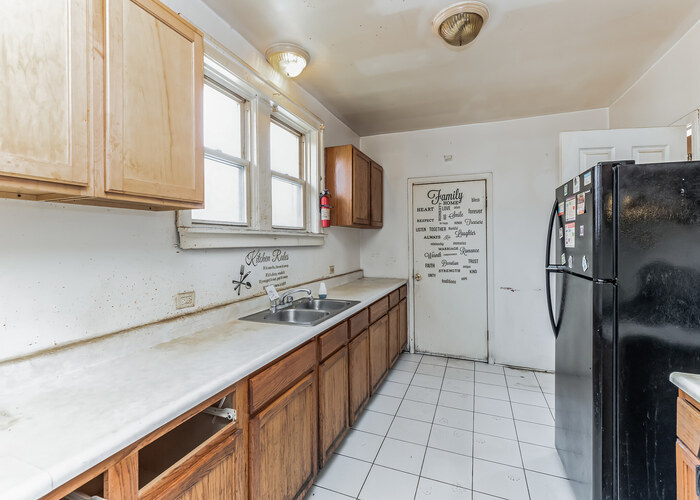 10805 South Normal Avenue Chicago, IL 60628 - Photo 21 of 26 a kitchen with stainless steel appliances granite countertop a refrigerator and a sink