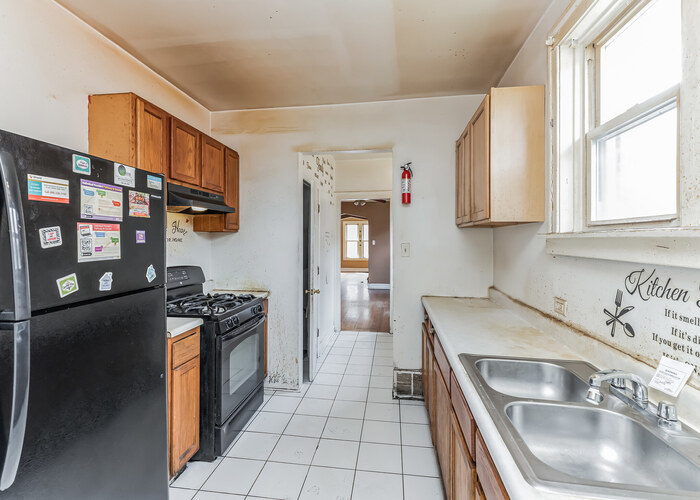 10805 South Normal Avenue Chicago, IL 60628 - Photo 23 of 26 a kitchen that has a sink and a stove