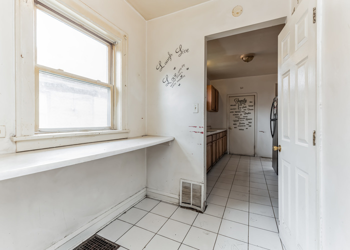10805 South Normal Avenue Chicago, IL 60628 - Photo 24 of 26 a view of a kitchen with a window and refrigerator