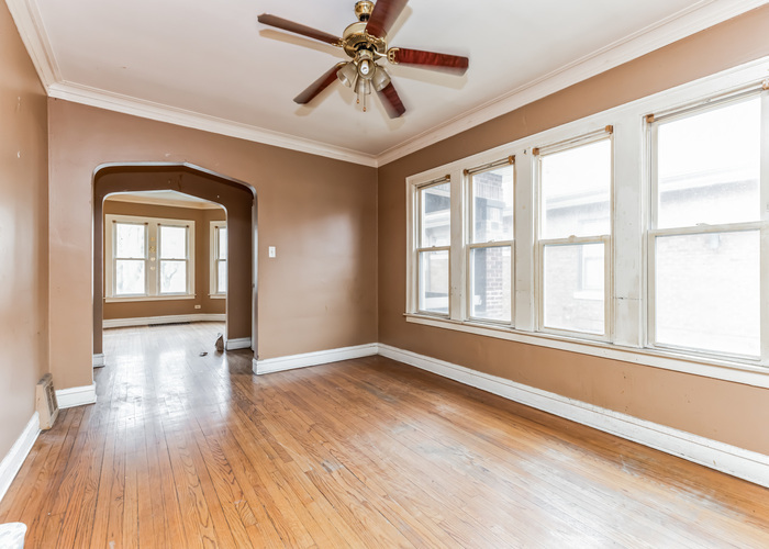 10805 South Normal Avenue Chicago, IL 60628 - Photo 8 of 26 a view of an empty room with window and wooden floor
