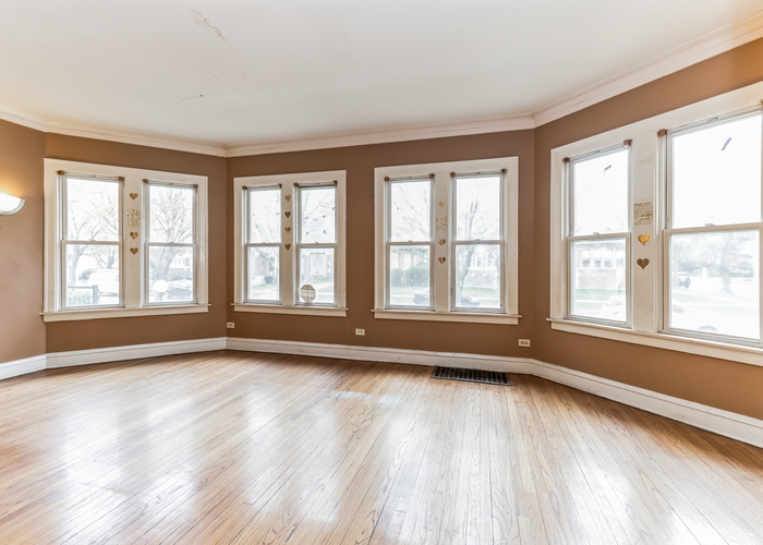 10805 South Normal Avenue Chicago, IL 60628 - Photo 10 of 26 a view of an empty room with wooden floor and a window