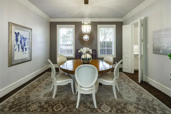 a dining room with furniture wooden floor a rug and a painting