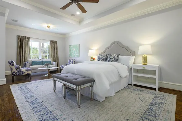 a spacious bedroom with a bed a table and a couch