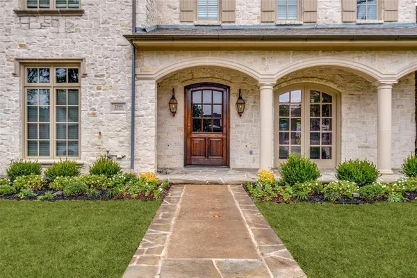 a front view of a house with a garden