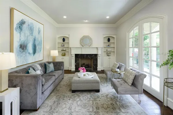 a living room with furniture window and a fireplace