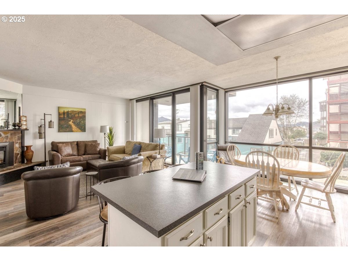 475 South Promenade, Unit 112 Seaside, OR 97138 - Photo 13 of 32 a living room with furniture and a large window