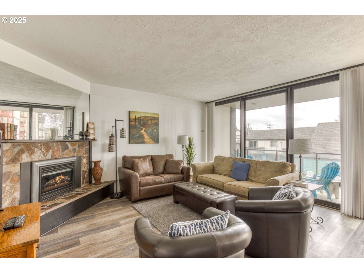 475 South Promenade, Unit 112 Seaside, OR 97138 - Photo 6 of 32 a living room with furniture and a fireplace