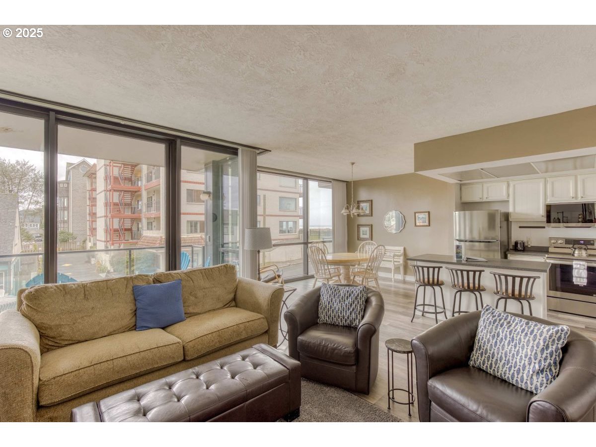 475 South Promenade, Unit 112 Seaside, OR 97138 - Photo 7 of 32 a living room with furniture and a large window