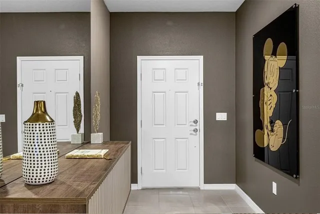 a bedroom with bed and a painting on the wall