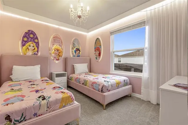 a bedroom with a large bed and a chandelier