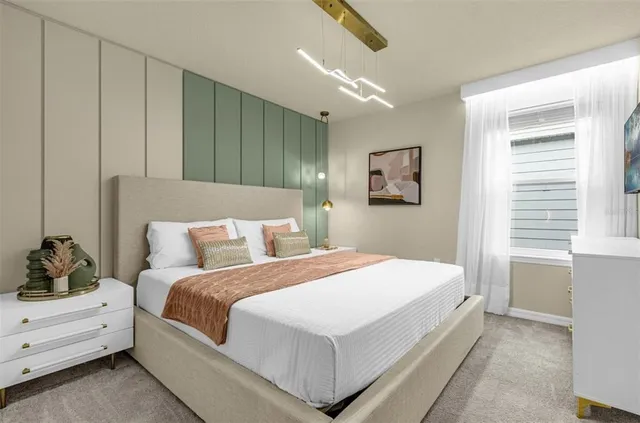 a bedroom with a large bed and a chandelier