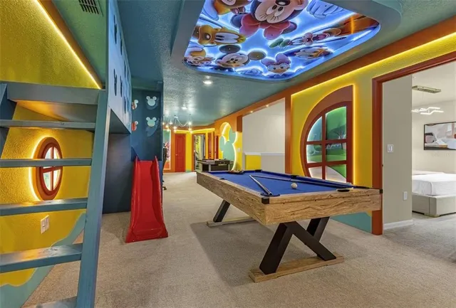 a living room with furniture and floor to ceiling windows