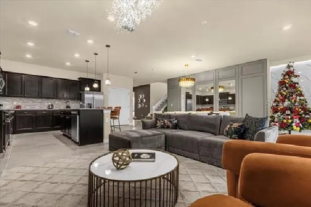 a living room with furniture and a chandelier