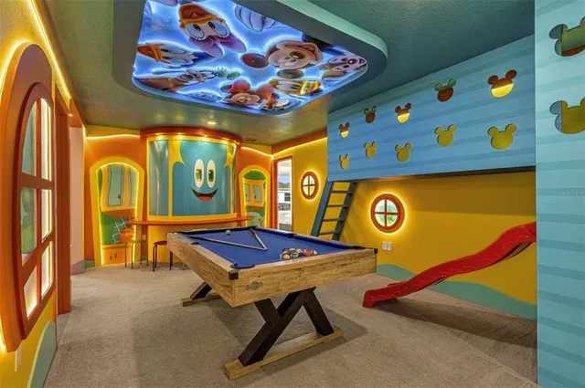 a room with lots of wooden furniture and a view of living room