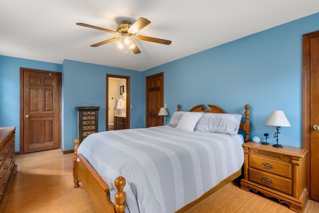 5 Blueberry Ridge Westfield, MA 01085 - Photo 15 of 34 a bedroom with a bed and a chandelier