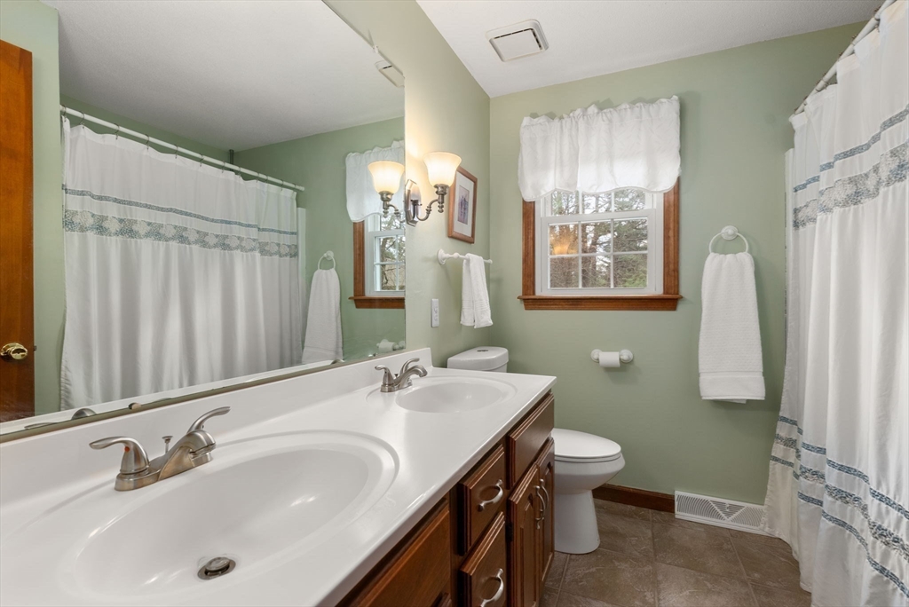 5 Blueberry Ridge Westfield, MA 01085 - Photo 18 of 34 a bathroom with double vanity sink a toilet and a mirror