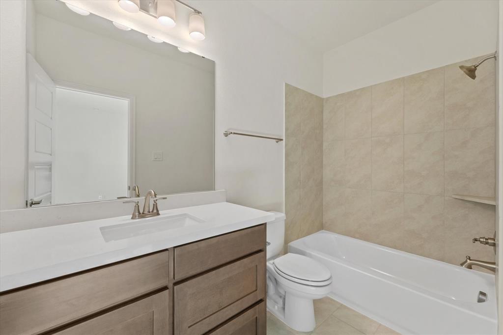 4626 Rillstone Road Midlothian, TX 76065 - Photo 32 of 40 Full bathroom featuring tub / shower combination, light tile patterned floors, and vanity